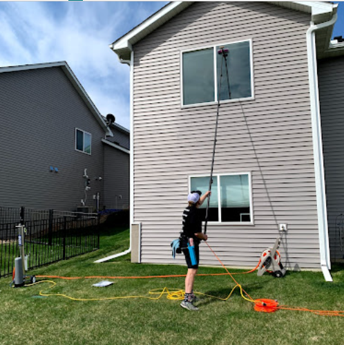 Exterior window cleaning on a two-story home